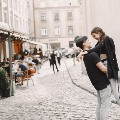 asian-boy-his-caucasian-girlfriend-casual-wear-standing-lviv-street-couple-hugging-each-other-while-walking-together-city