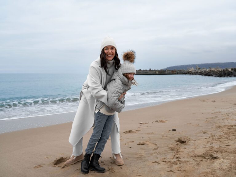 slow-travel-tours-full-shot-mother-kid-beach